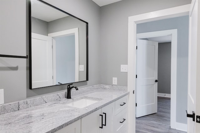 bathroom featuring wood-type flooring and vanity