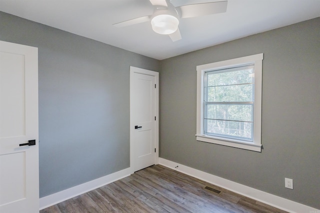 empty room featuring hardwood / wood-style floors and ceiling fan