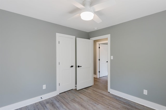 unfurnished bedroom featuring light hardwood / wood-style floors and ceiling fan