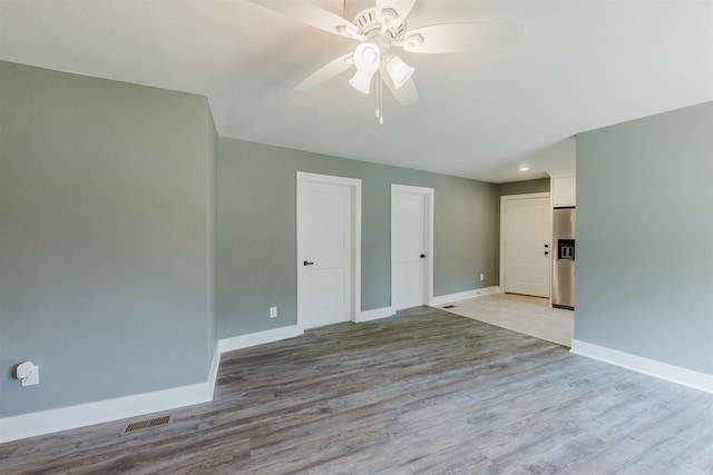 unfurnished room featuring ceiling fan and light wood-type flooring