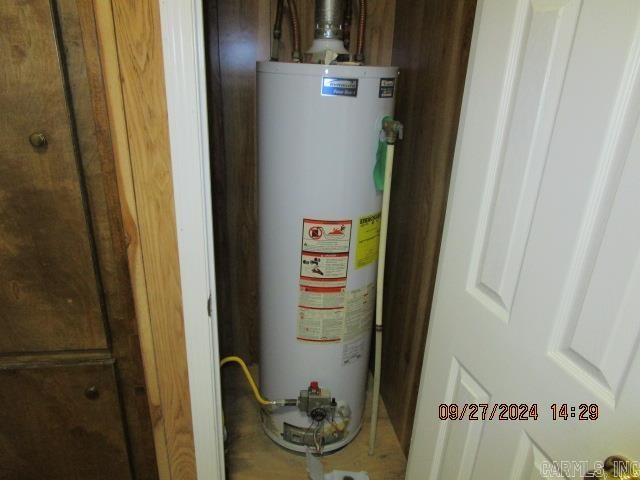 utility room with water heater