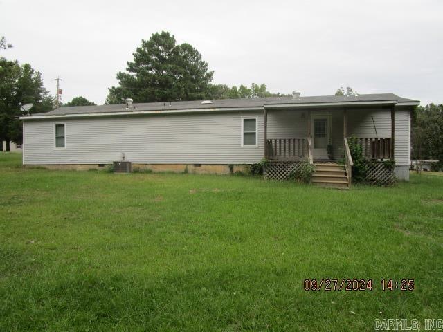 back of property with a yard and central air condition unit