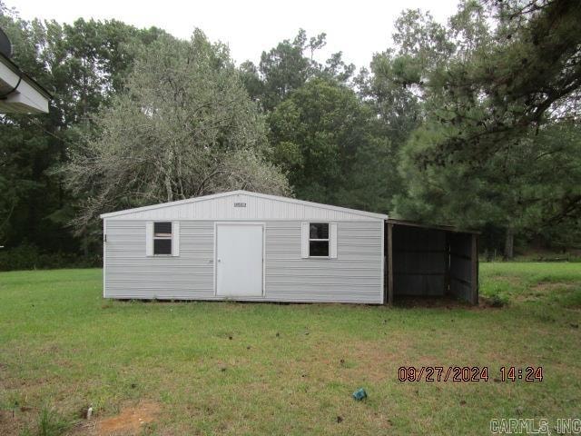 view of outdoor structure with a yard