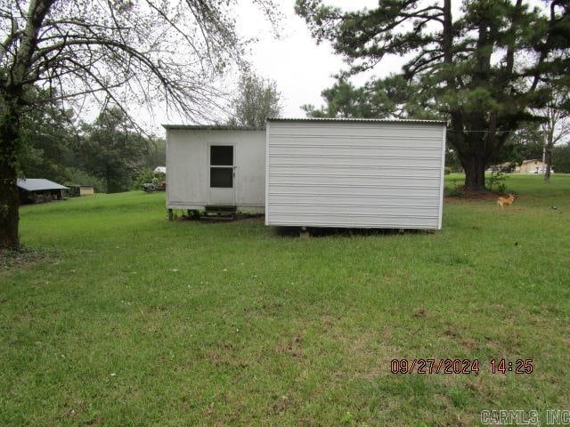 view of outbuilding with a yard