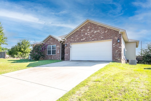 view of front of property with cooling unit, a front yard, and a garage