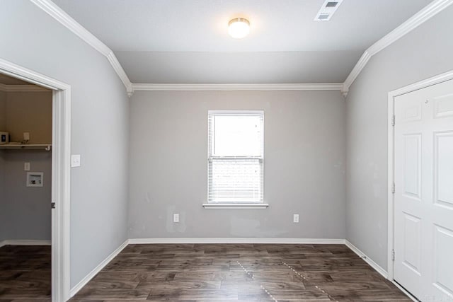 empty room featuring ornamental molding and dark wood-type flooring