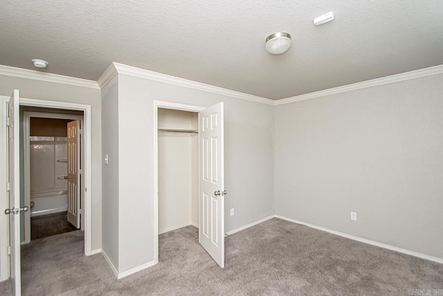 unfurnished bedroom with light colored carpet, a textured ceiling, a closet, and ornamental molding