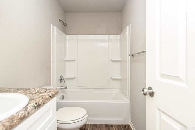 full bathroom featuring hardwood / wood-style flooring, vanity, toilet, and shower / bath combination