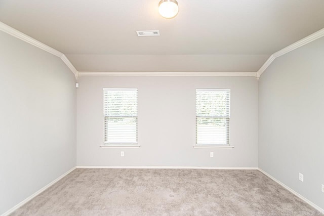 empty room featuring light carpet, lofted ceiling, and plenty of natural light