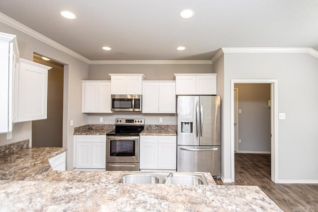 kitchen with appliances with stainless steel finishes, crown molding, and white cabinetry