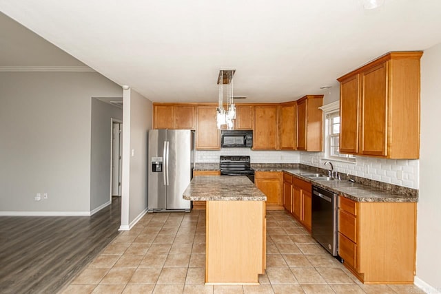 kitchen with black appliances, crown molding, a center island, light hardwood / wood-style flooring, and decorative light fixtures