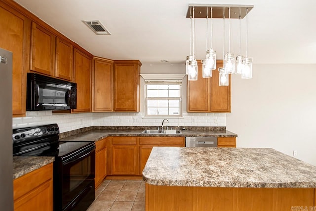 kitchen featuring pendant lighting, sink, a kitchen island, backsplash, and black appliances