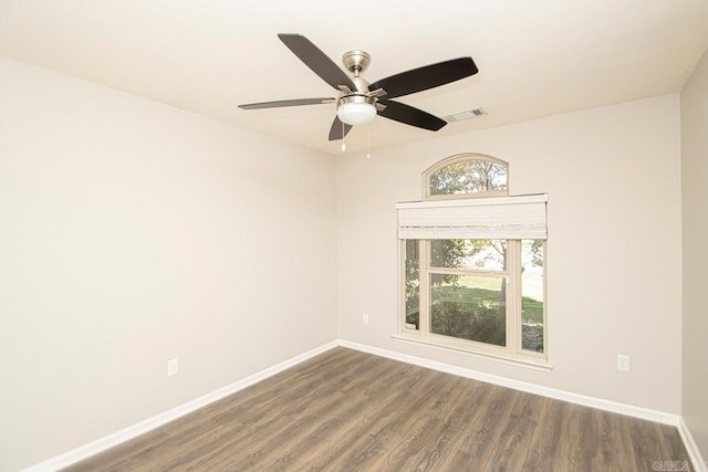 empty room with dark hardwood / wood-style floors and ceiling fan