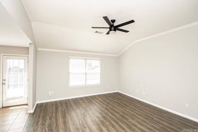 unfurnished room featuring a healthy amount of sunlight, vaulted ceiling, dark wood-type flooring, and ceiling fan