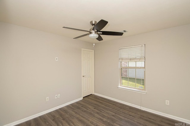 empty room with ceiling fan and dark hardwood / wood-style floors