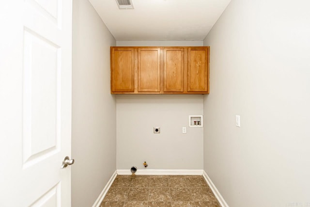 clothes washing area featuring hookup for a washing machine, cabinets, gas dryer hookup, and hookup for an electric dryer