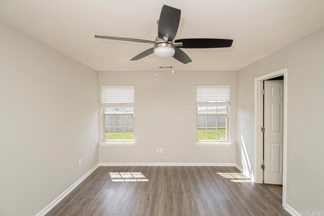 unfurnished room with ceiling fan and dark wood-type flooring