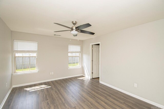 spare room with ceiling fan and dark hardwood / wood-style floors