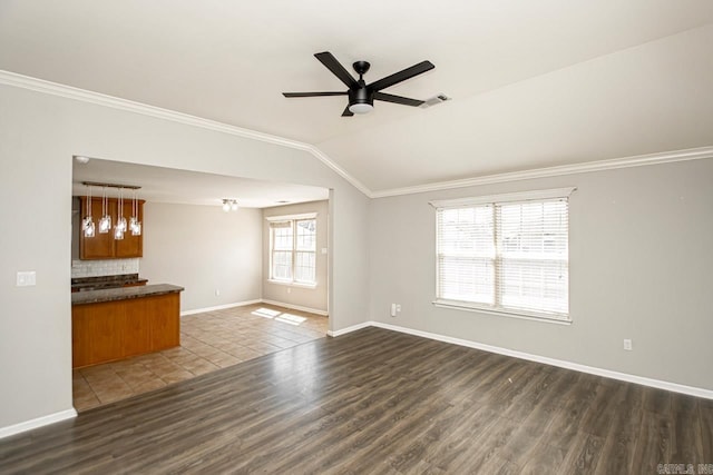 unfurnished living room with crown molding, lofted ceiling, dark hardwood / wood-style floors, and ceiling fan