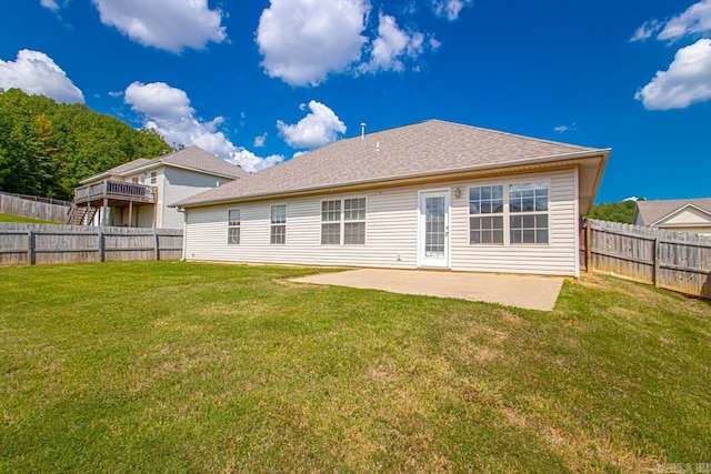 rear view of house featuring a lawn and a patio area