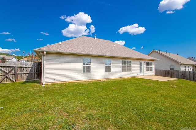 back of house with a lawn and a patio