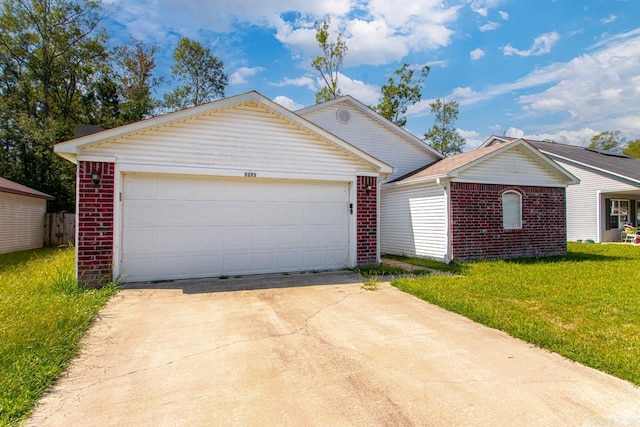 single story home with a front yard and a garage