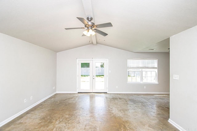 empty room featuring ceiling fan, lofted ceiling with beams, concrete flooring, and a healthy amount of sunlight