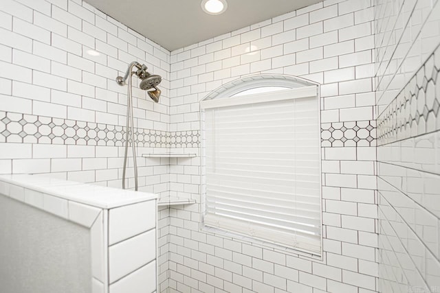 bathroom with a tile shower