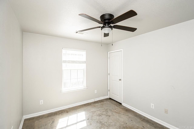 spare room featuring ceiling fan and a textured ceiling