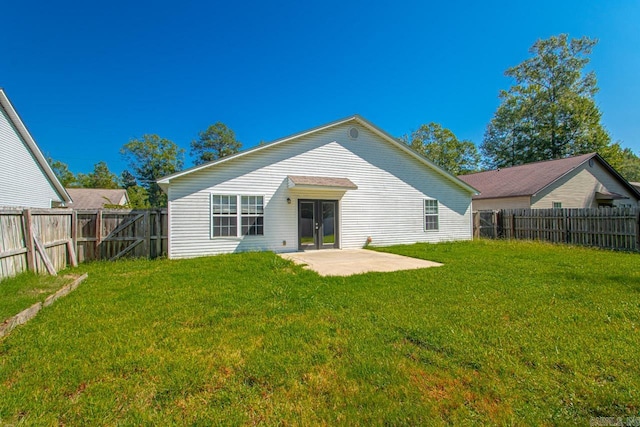 back of property with a patio and a yard