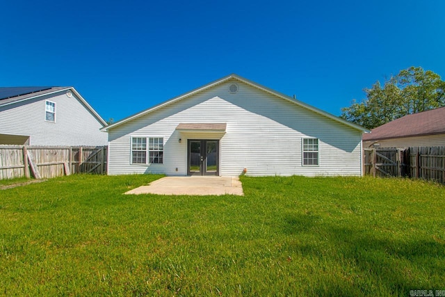 back of property with a yard, french doors, and a patio area