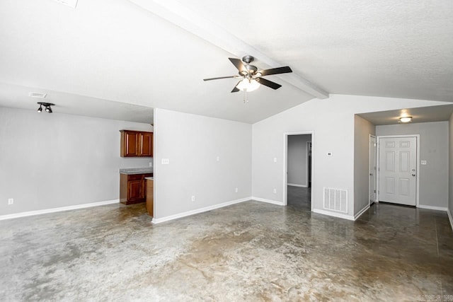 unfurnished room featuring a textured ceiling, lofted ceiling with beams, and ceiling fan