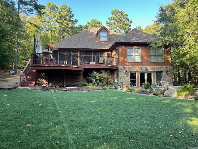 back of property with a yard and a wooden deck