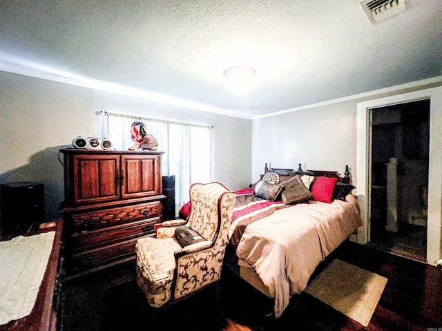 bedroom featuring a textured ceiling and crown molding