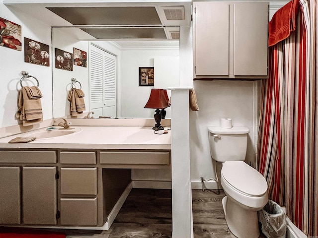 bathroom with vanity, hardwood / wood-style flooring, and toilet