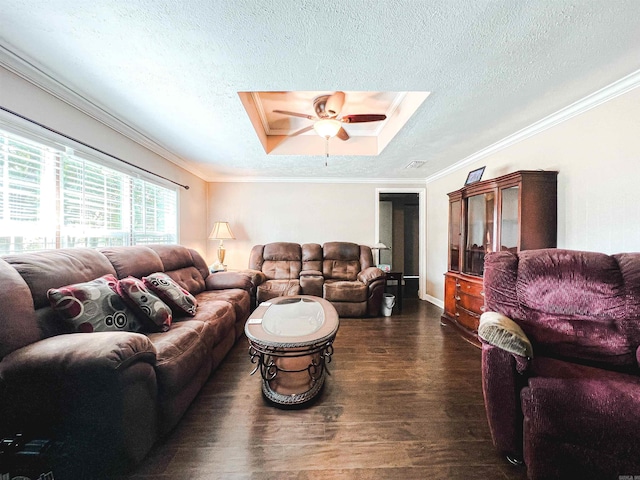 living room featuring ornamental molding, dark wood-type flooring, ceiling fan, and a skylight