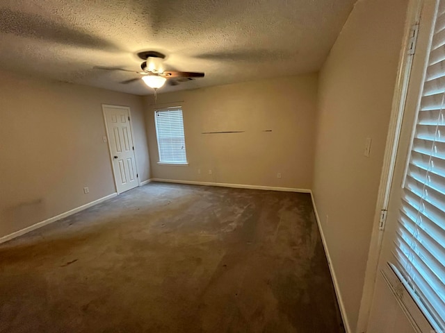 carpeted spare room with ceiling fan and a textured ceiling