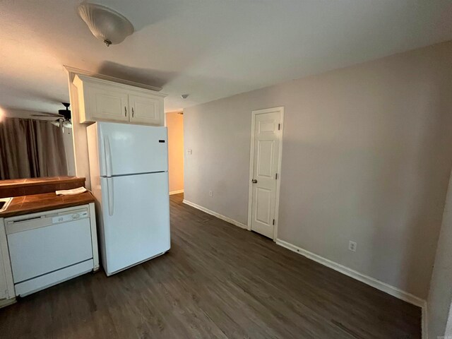 kitchen with white appliances, dark hardwood / wood-style floors, ceiling fan, and white cabinets