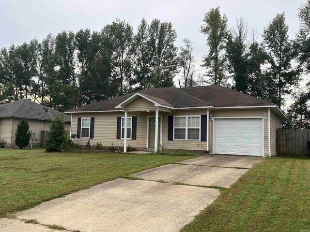 single story home featuring a front lawn and a garage