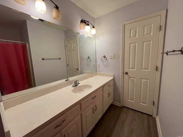 bathroom with vanity and hardwood / wood-style flooring