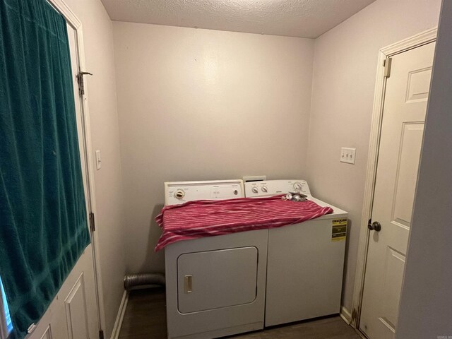 laundry area with a textured ceiling and washer and clothes dryer