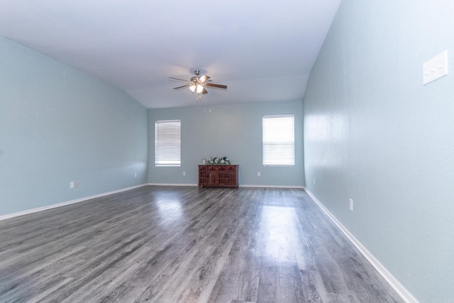 unfurnished living room with ceiling fan, lofted ceiling, and dark hardwood / wood-style floors