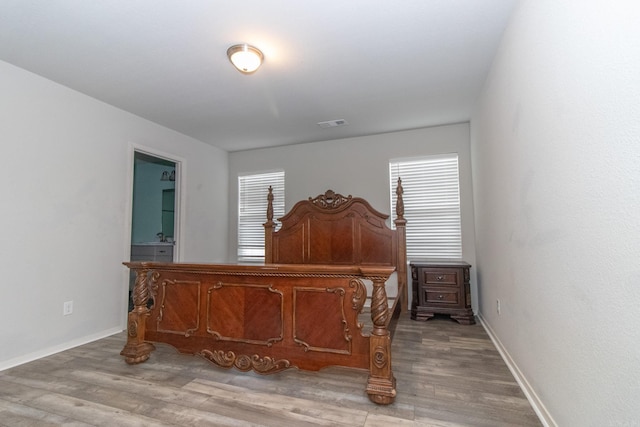 bedroom featuring light wood-type flooring and multiple windows