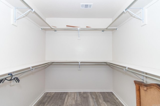 walk in closet featuring dark hardwood / wood-style floors