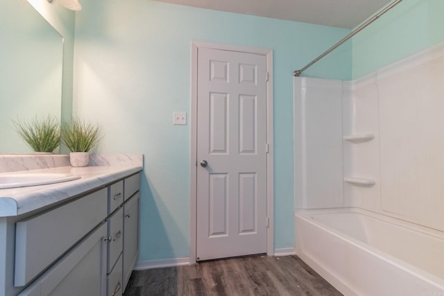 bathroom with vanity, bathing tub / shower combination, and hardwood / wood-style floors