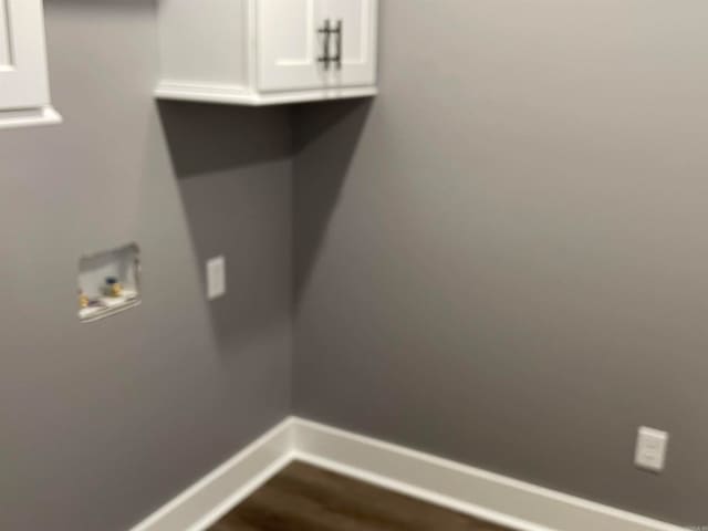 clothes washing area with cabinets, dark hardwood / wood-style floors, and hookup for a washing machine