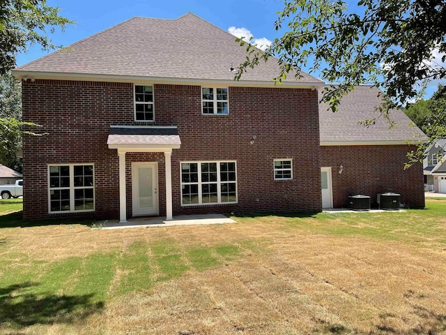 back of house featuring a lawn, a patio, and central AC