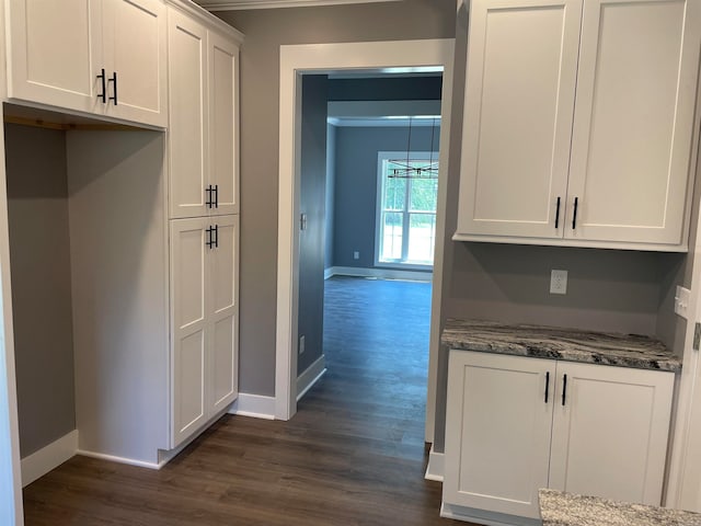 kitchen featuring dark stone counters, white cabinetry, and dark hardwood / wood-style floors