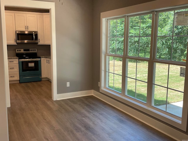 kitchen featuring appliances with stainless steel finishes, white cabinets, and plenty of natural light