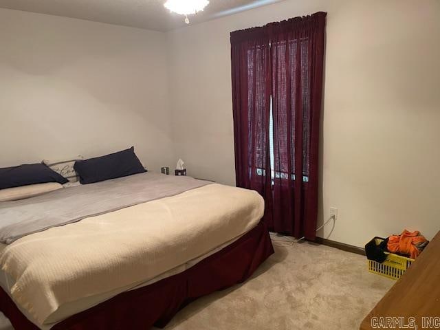 bedroom featuring light colored carpet